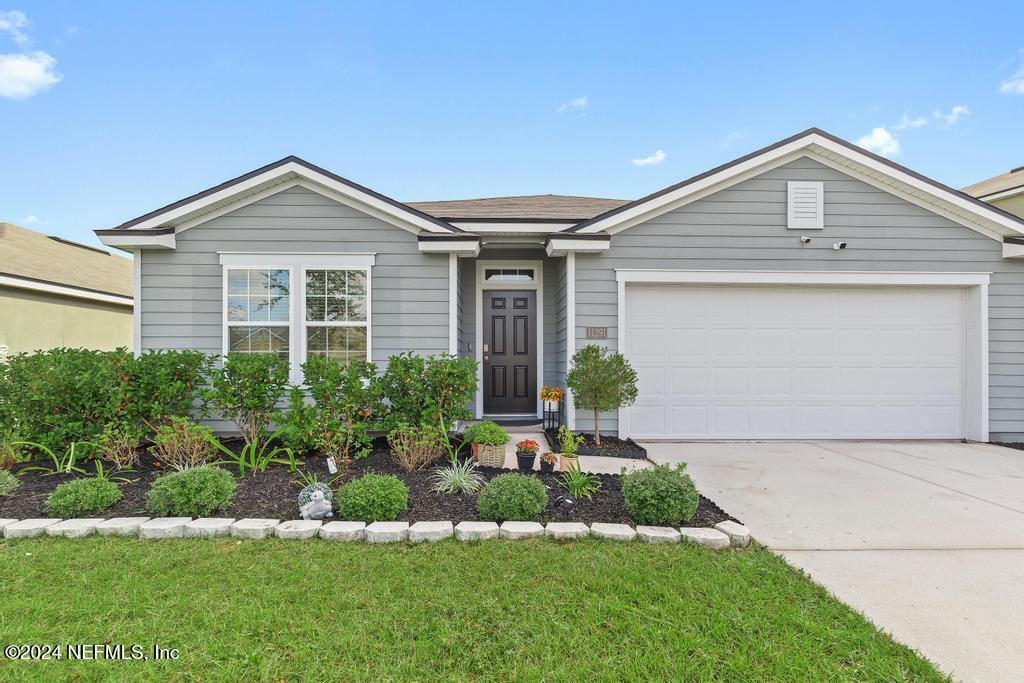 11291 Sheepshead Lane Jacksonville, FL 32226 - Photo 4 of 54 a front view of a house with a yard and garage