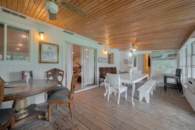a view of a dining room with furniture a rug and wooden floor
