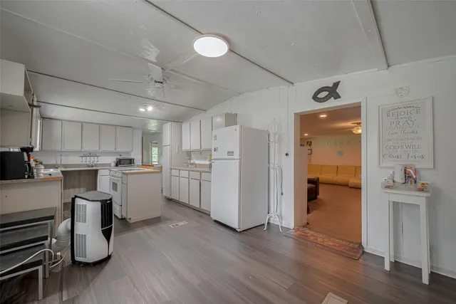 a kitchen with a refrigerator and a sink