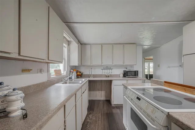 a kitchen with a sink stove and cabinets