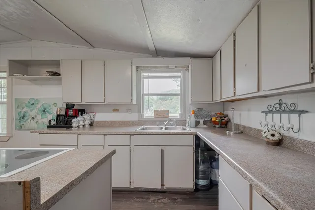 a kitchen with a sink cabinets and window