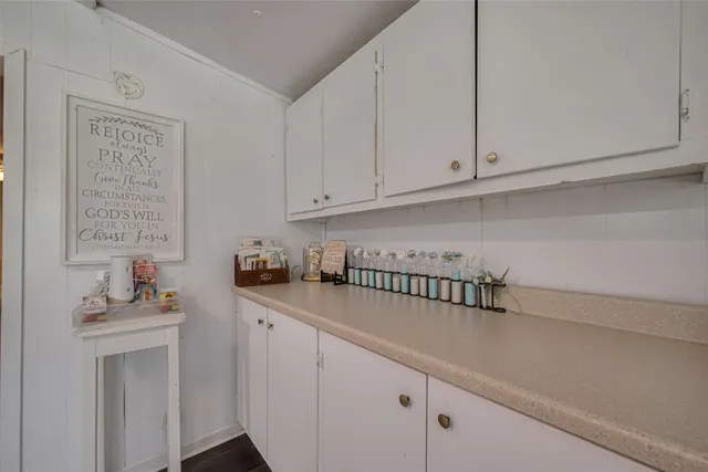 a kitchen with white cabinets and a sink