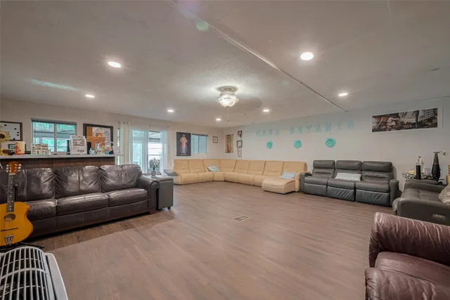 a view of a dining room with furniture a rug and wooden floor