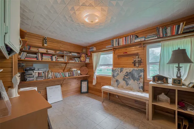 a reading room with furniture and a book shelf