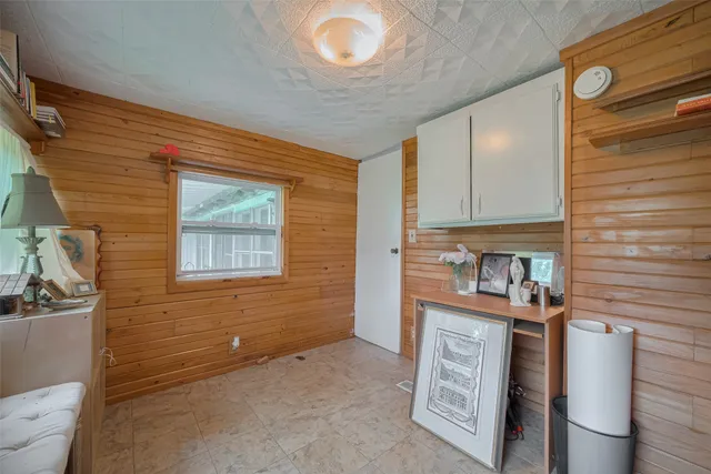 a view of kitchen cabinets and window