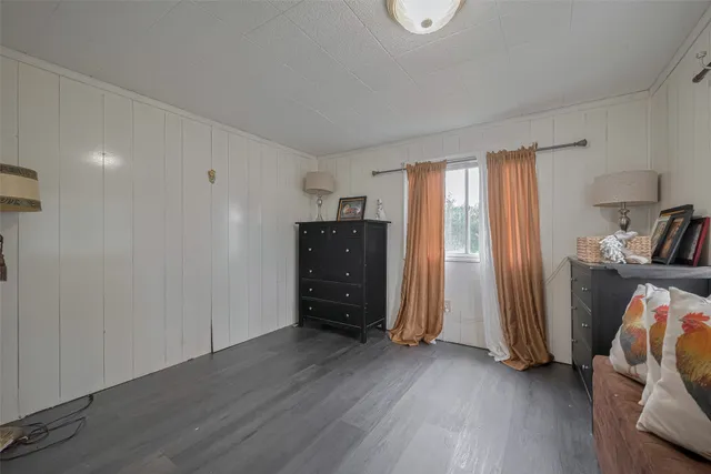 an empty room with wooden floor and closet