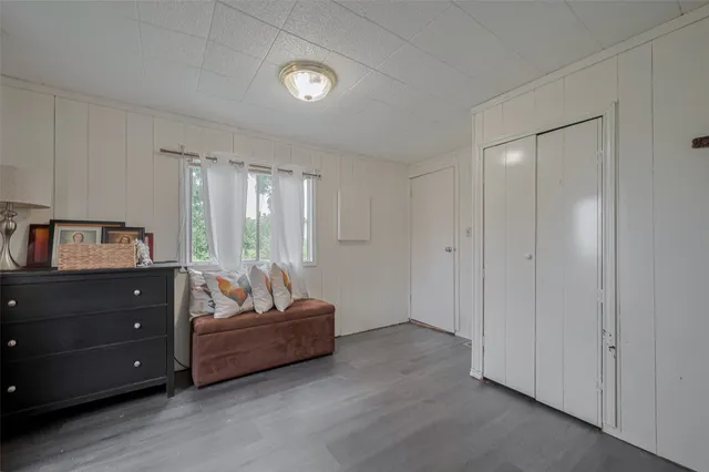 a living room with furniture and a dresser