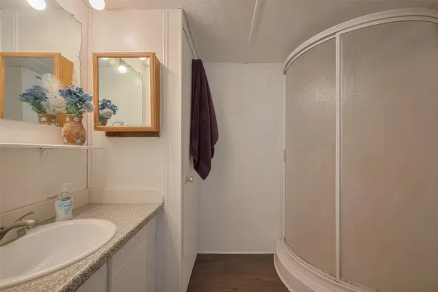 a bathroom with a granite countertop sink and a mirror