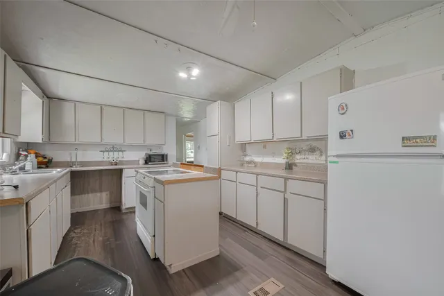 an empty room with wooden floor and closet