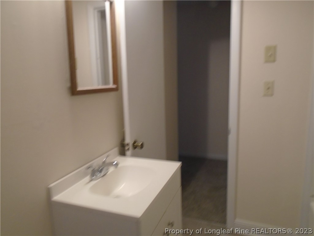 5858 Columbine Road Fayetteville, NC 28306 - Photo 7 of 10 a bathroom with a sink and a mirror