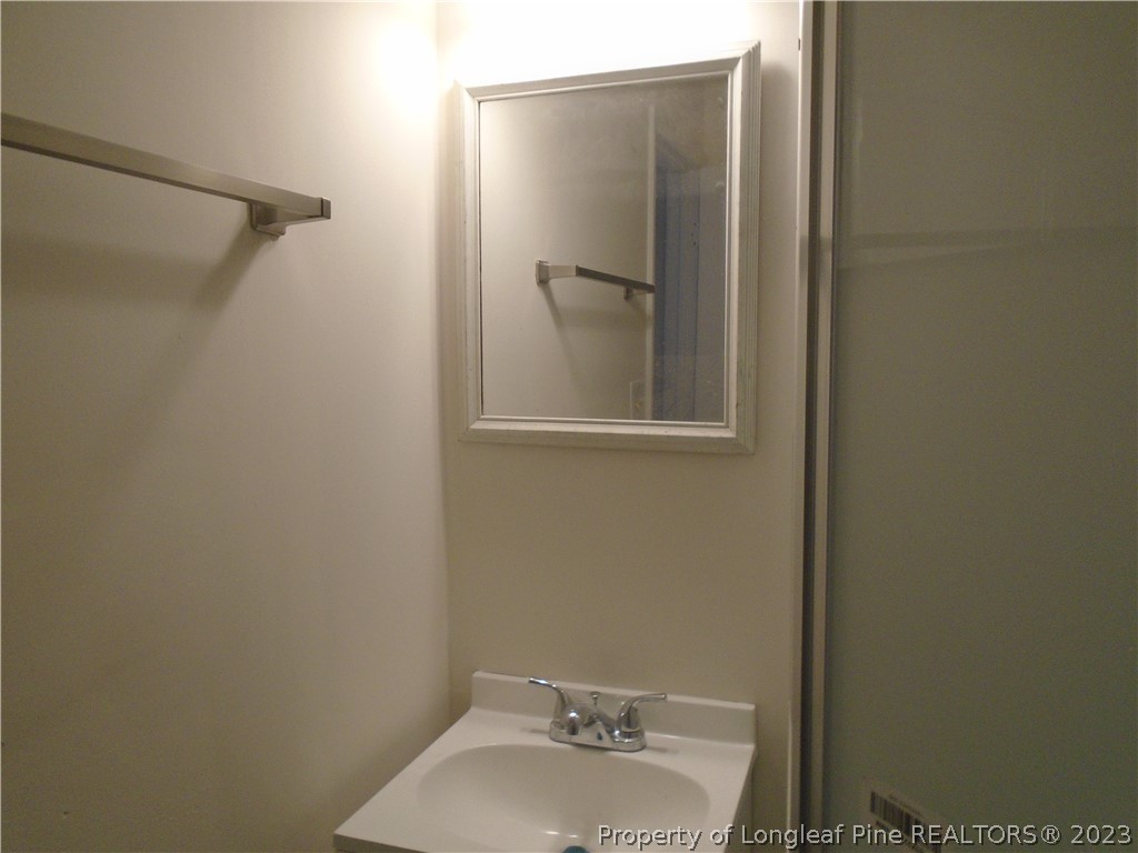 5858 Columbine Road Fayetteville, NC 28306 - Photo 10 of 10 a bathroom with a sink and mirror