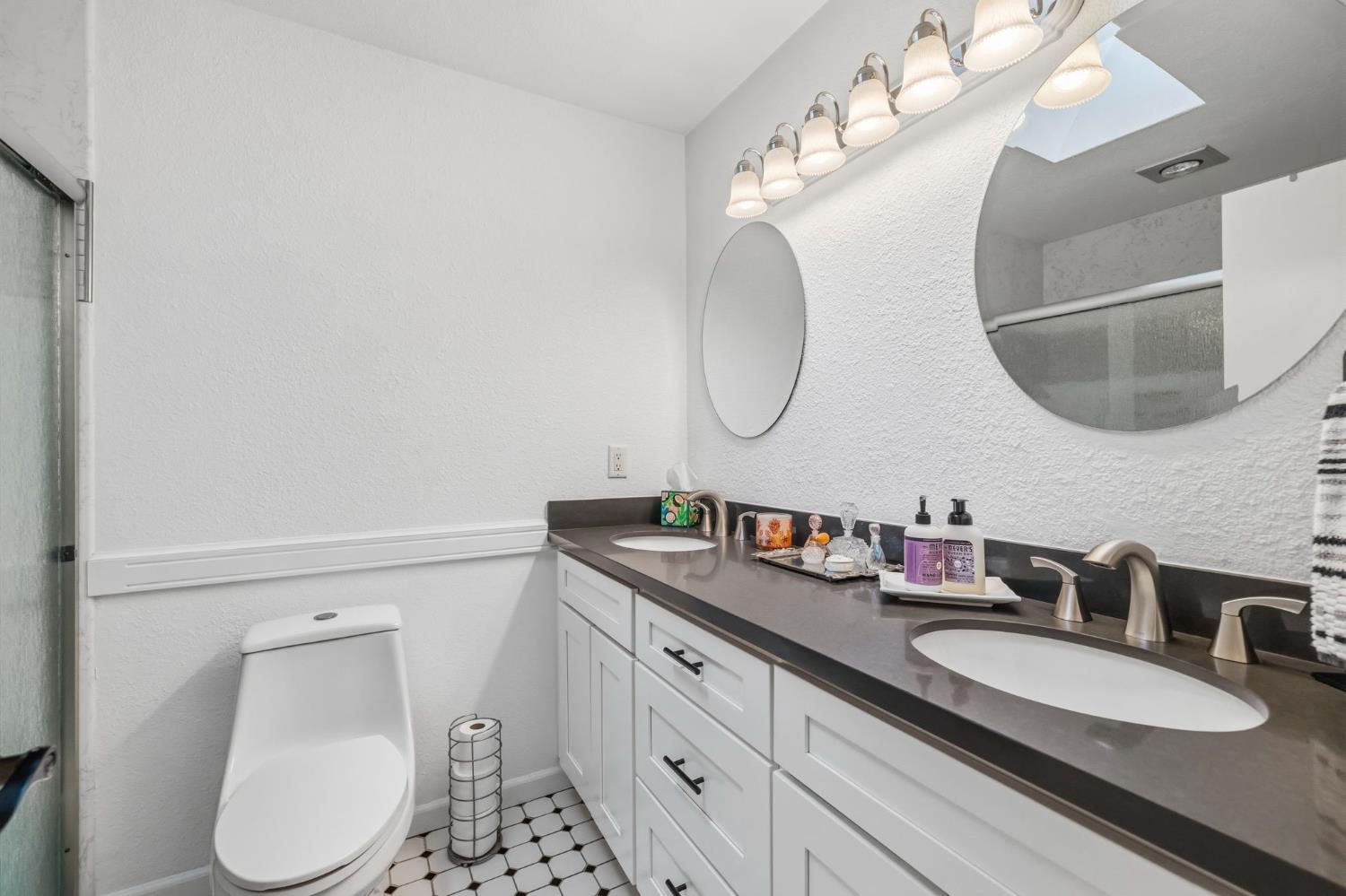 11460 Racetrack Road Sonora, CA 95370 - Photo 28 of 46 a bathroom with a granite countertop sink mirror and toilet