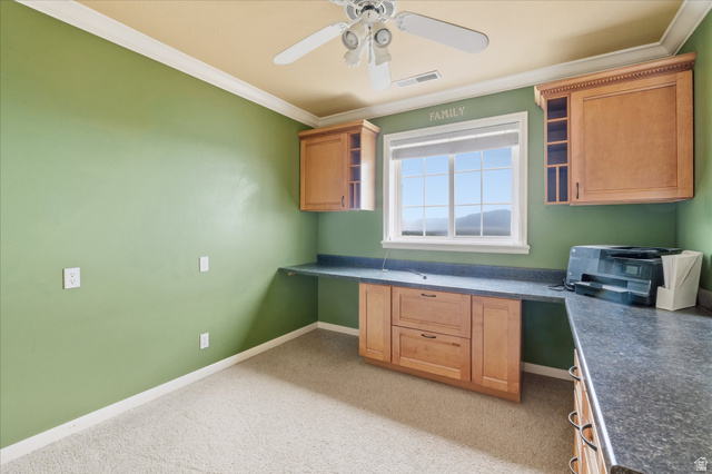 2887 View Crest Circle North Logan, UT 84341 - Photo 19 of 37 Kitchen with built in study area, dark countertops, ornamental molding, ceiling fan, and open shelves