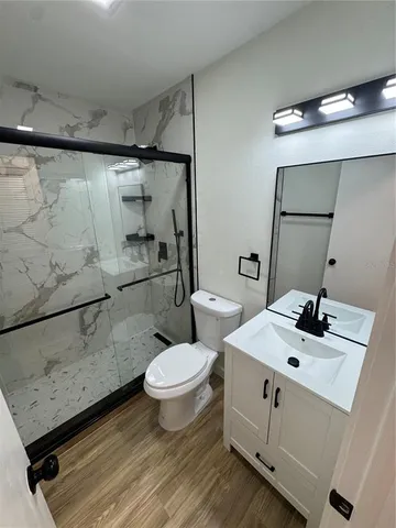 a bathroom with a sink toilet and shower