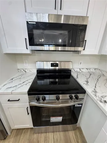 a stove top oven sitting inside of a kitchen
