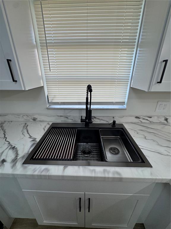 500 Vía Tripoli, Unit 3 Punta Gorda, FL 33950 - Photo 10 of 21 a close view of a sink a barbeque and wooden floor