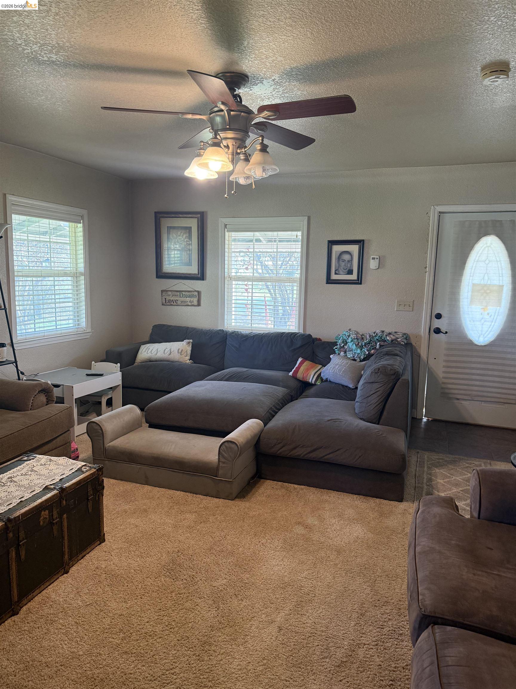 9436 Fraguero Road Sonora, CA 95370 - Photo 17 of 18 a living room with furniture and a chandelier
