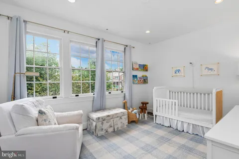 a bedroom with furniture and a large window