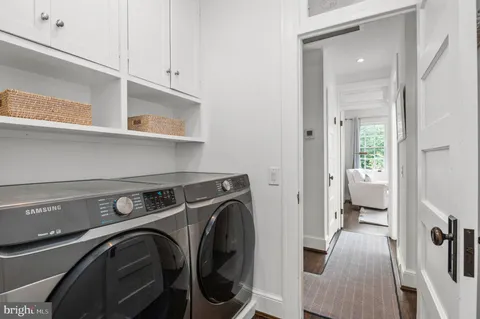a view of a hallway with washer and dryer