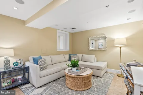 a living room with furniture and a lamp