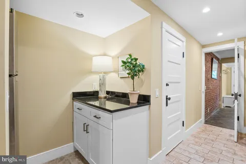 a hallway with sink and mirror