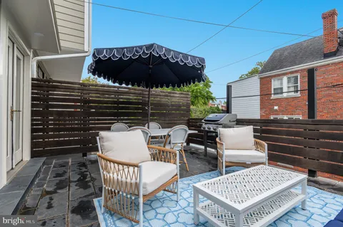 a view of a patio with a table and chairs