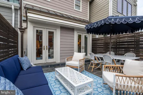 a view of a patio with couches chairs and a table and chairs