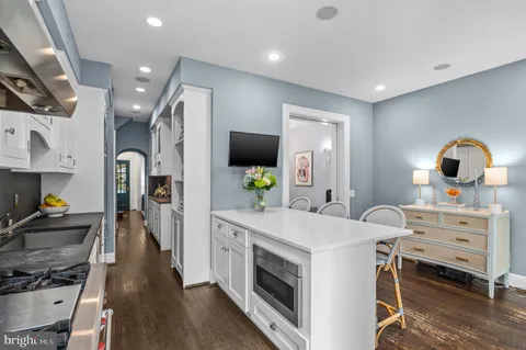a kitchen with a sink appliances and cabinets