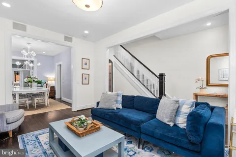 a living room with furniture rug and wooden floor