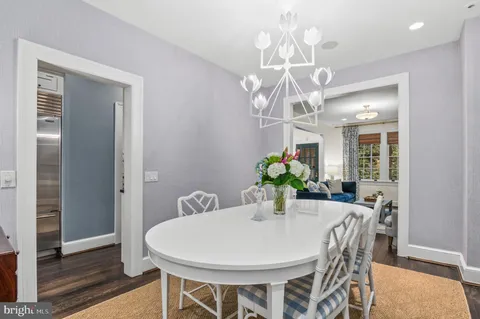 a view of a dining room with furniture and chandelier
