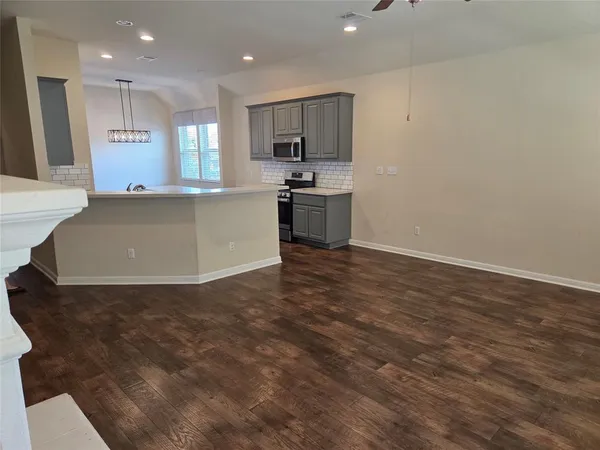 a kitchen with stainless steel appliances a refrigerator sink and microwave