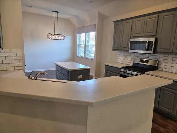 a view of kitchen with cabinets and wooden floor