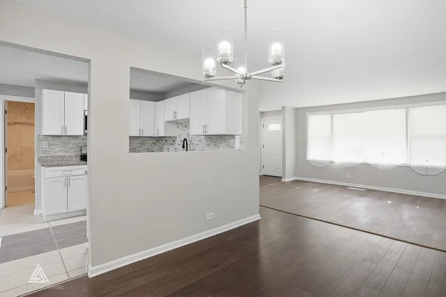 a view of a kitchen with an empty space and a window