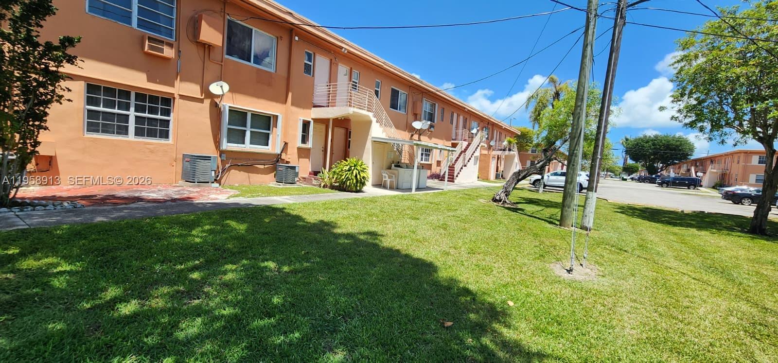 3670 Southwest 10th Street, Unit 10B Miami, FL 33135 - Photo 13 of 14 a view of a building with a yard