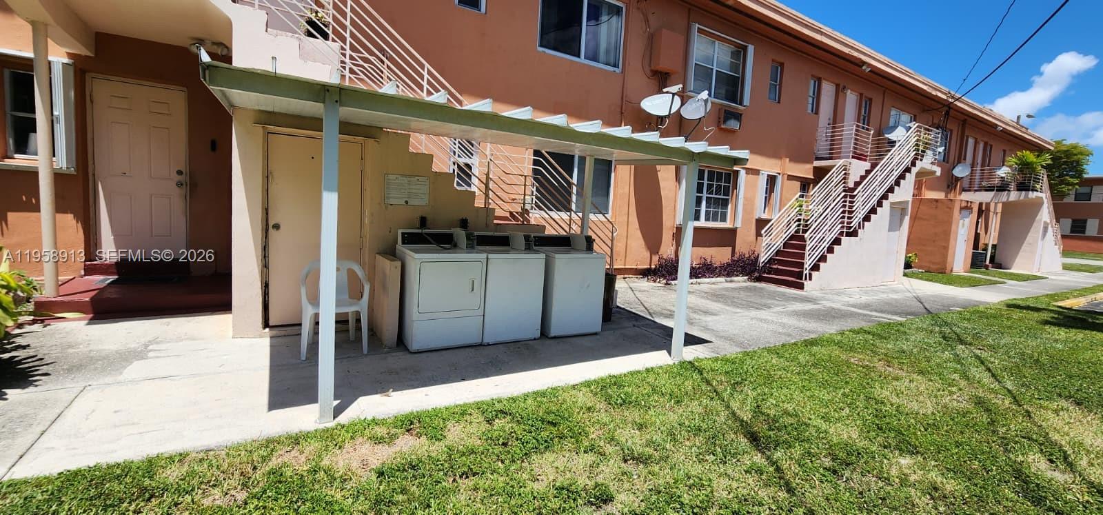 3670 Southwest 10th Street, Unit 10B Miami, FL 33135 - Photo 14 of 14 a view of a house with many windows and a yard