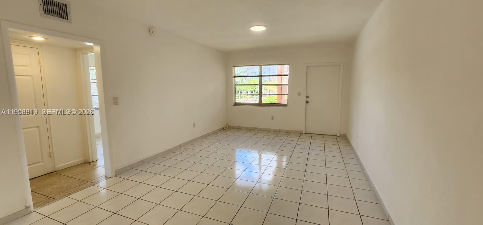 3670 Southwest 10th Street, Unit 10B Miami, FL 33135 - Photo 3 of 14 a view of an empty room and window