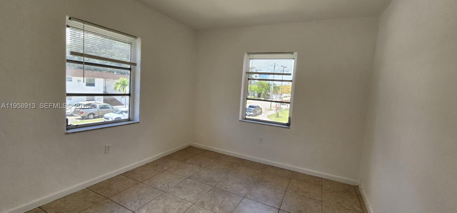 3670 Southwest 10th Street, Unit 10B Miami, FL 33135 - Photo 5 of 14 an empty room with windows