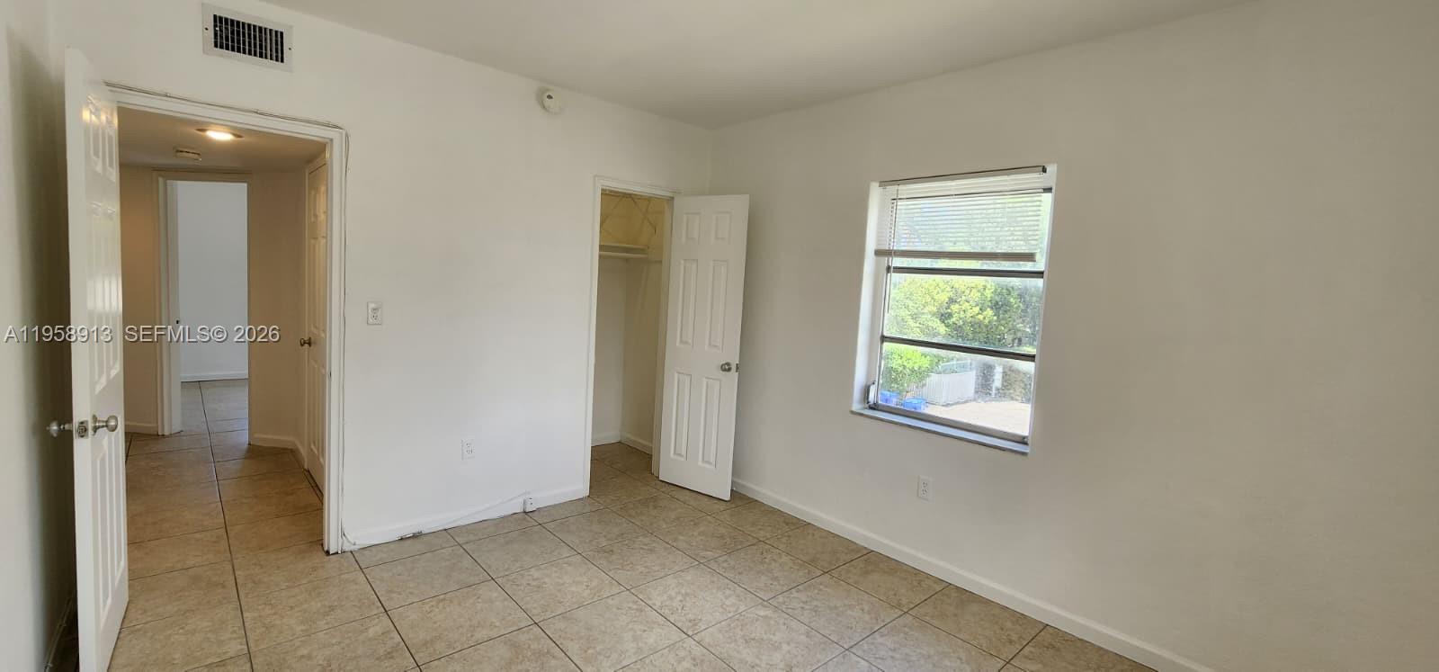 3670 Southwest 10th Street, Unit 10B Miami, FL 33135 - Photo 7 of 14 an empty room with windows and closet