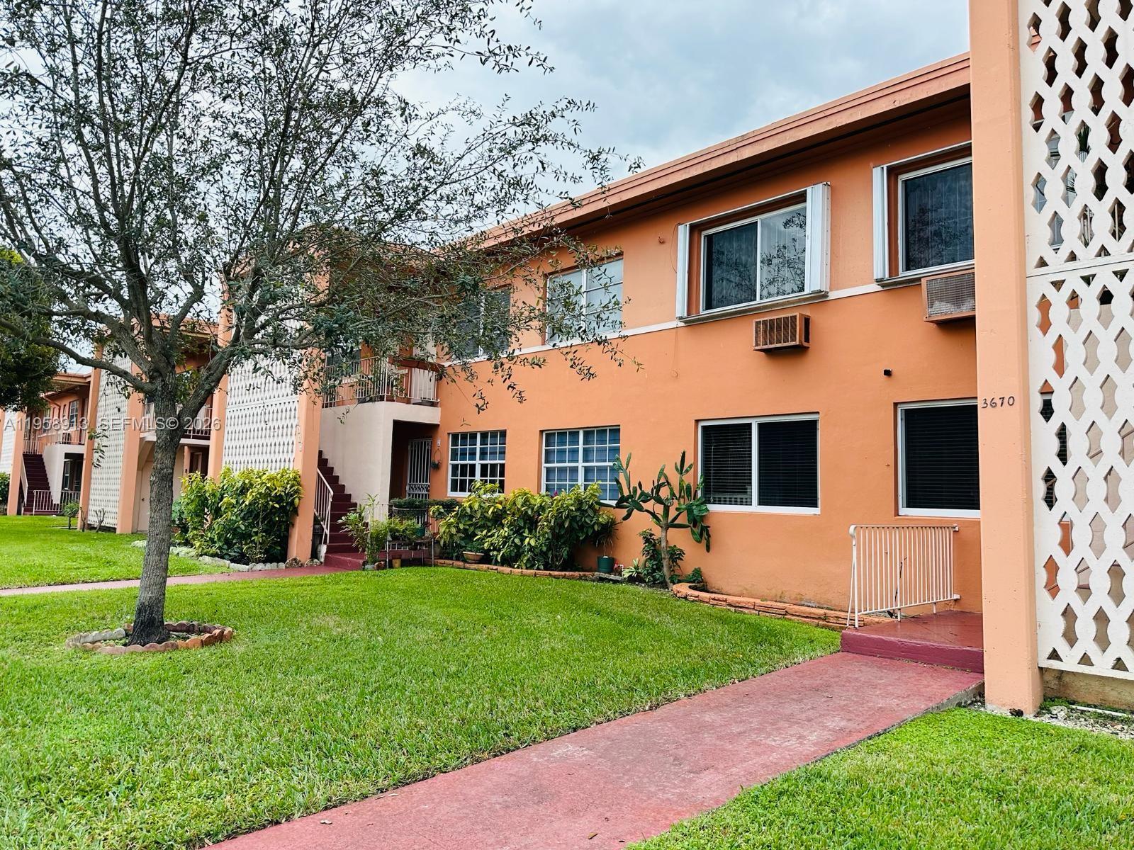 3670 Southwest 10th Street, Unit 10B Miami, FL 33135 - Photo 10 of 14 a front view of a house with a yard and trees