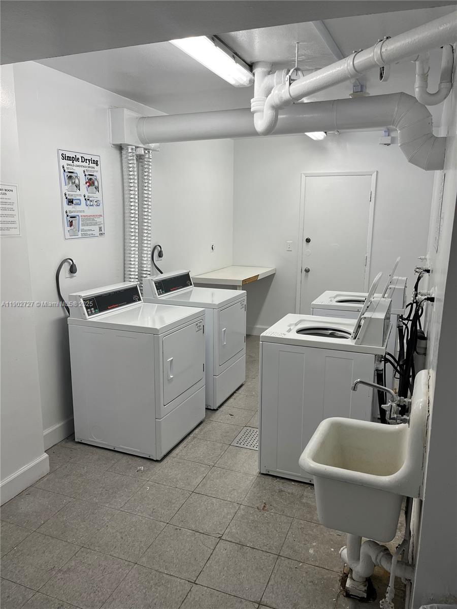 5005 Collins Avenue, Unit 923 Miami Beach, FL 33140 - Photo 15 of 17 a utility room with sink dryer and washer