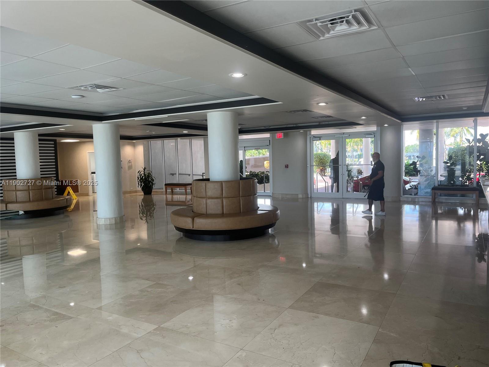 5005 Collins Avenue, Unit 923 Miami Beach, FL 33140 - Photo 3 of 17 a lobby with furniture and a large window