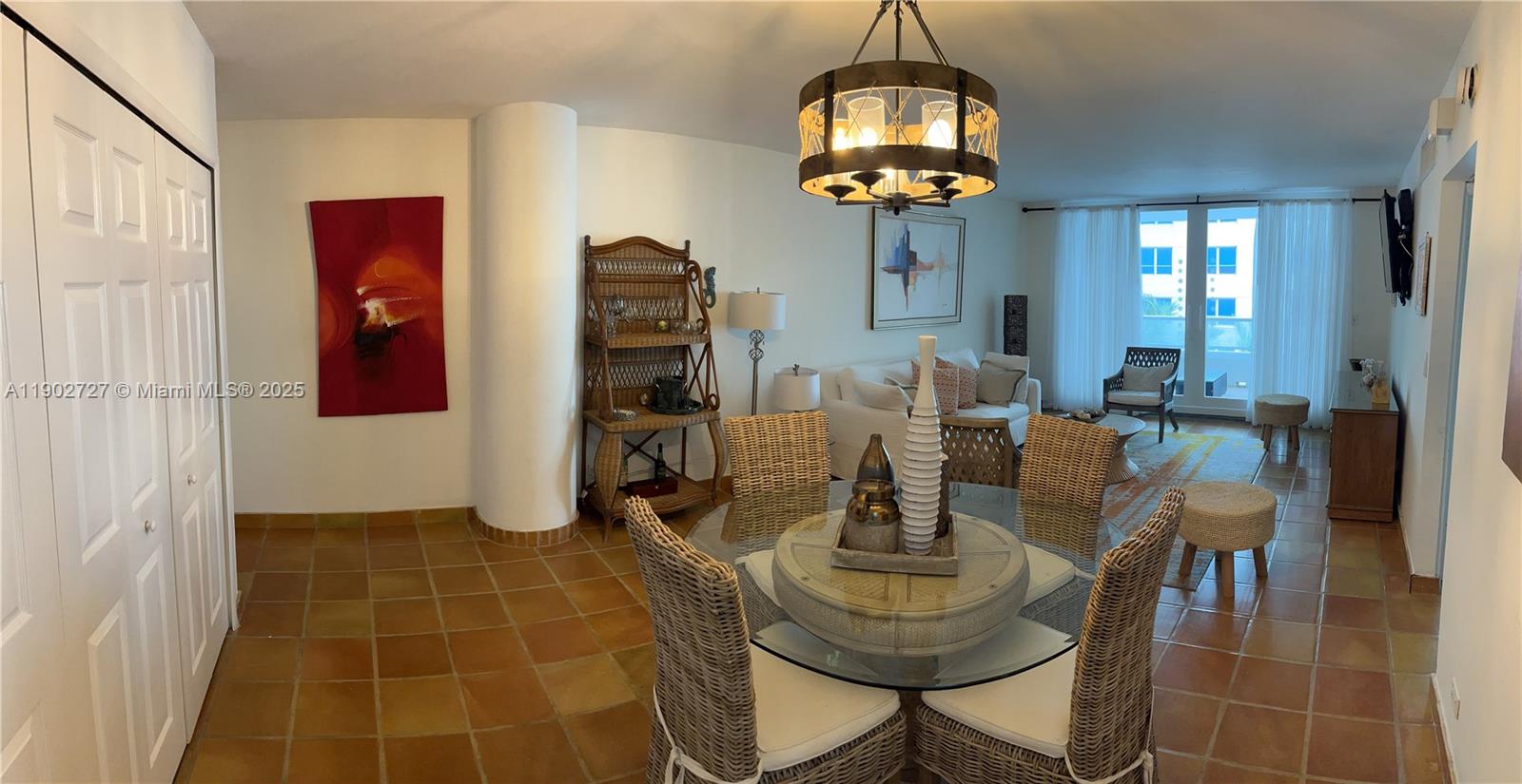 5005 Collins Avenue, Unit 923 Miami Beach, FL 33140 - Photo 4 of 17 a view of a dining room with furniture and chandelier