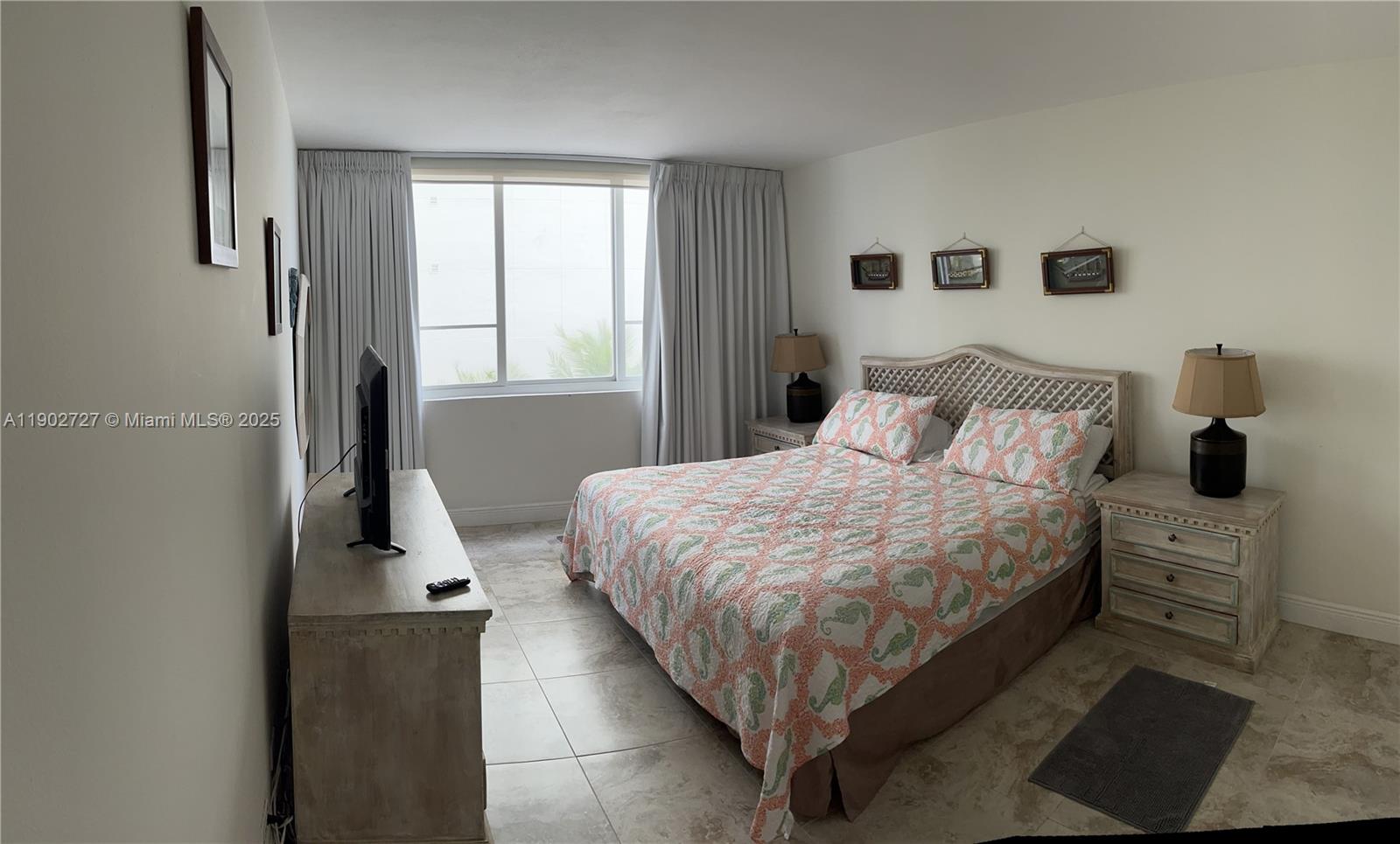 5005 Collins Avenue, Unit 923 Miami Beach, FL 33140 - Photo 7 of 17 a bedroom with a bed and wooden floor