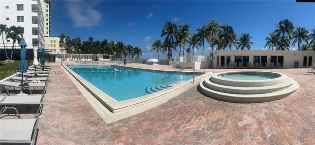 a view of a swimming pool with a patio