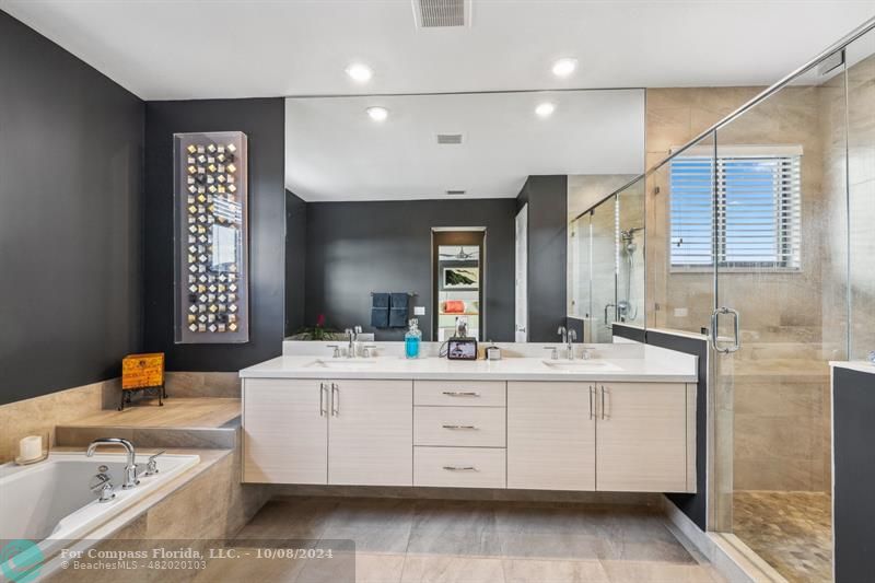 10610 Waves Way Parkland, FL 33076 - Photo 24 of 53 a bathroom with a double vanity sink mirror and bathtub