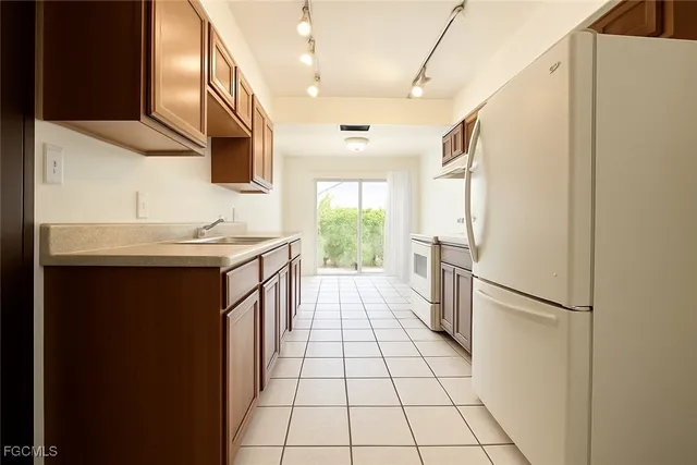 a kitchen with a sink a refrigerator a washer and dryer
