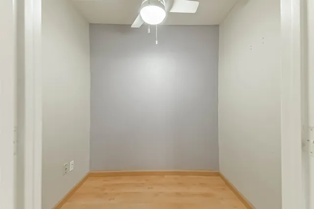 a view of a room with wooden floor and brick walls