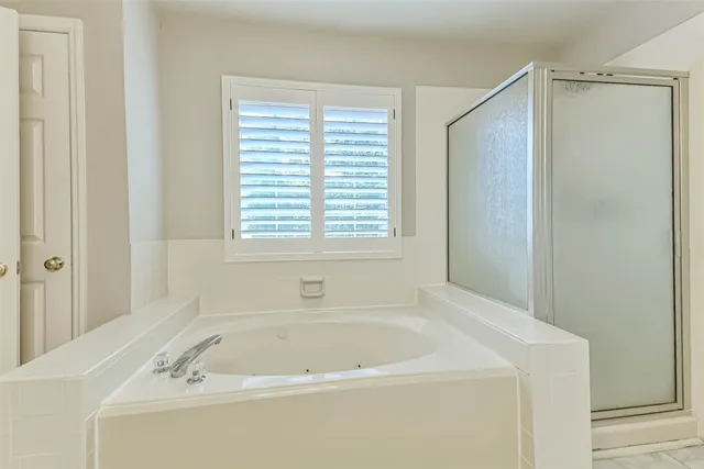 a white bath tub sitting next to a window