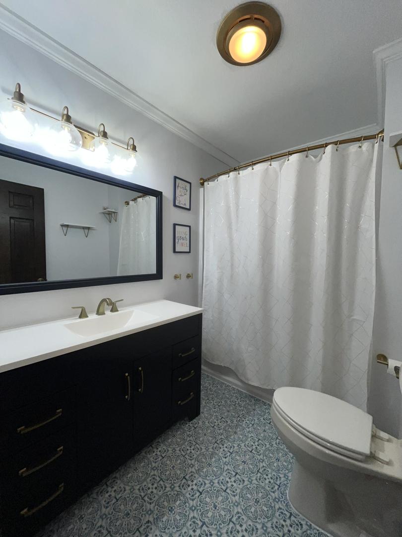 57 Jibby Estates Sullivan, IL 61951 - Photo 11 of 16 a bathroom with a double vanity sink toilet and mirror