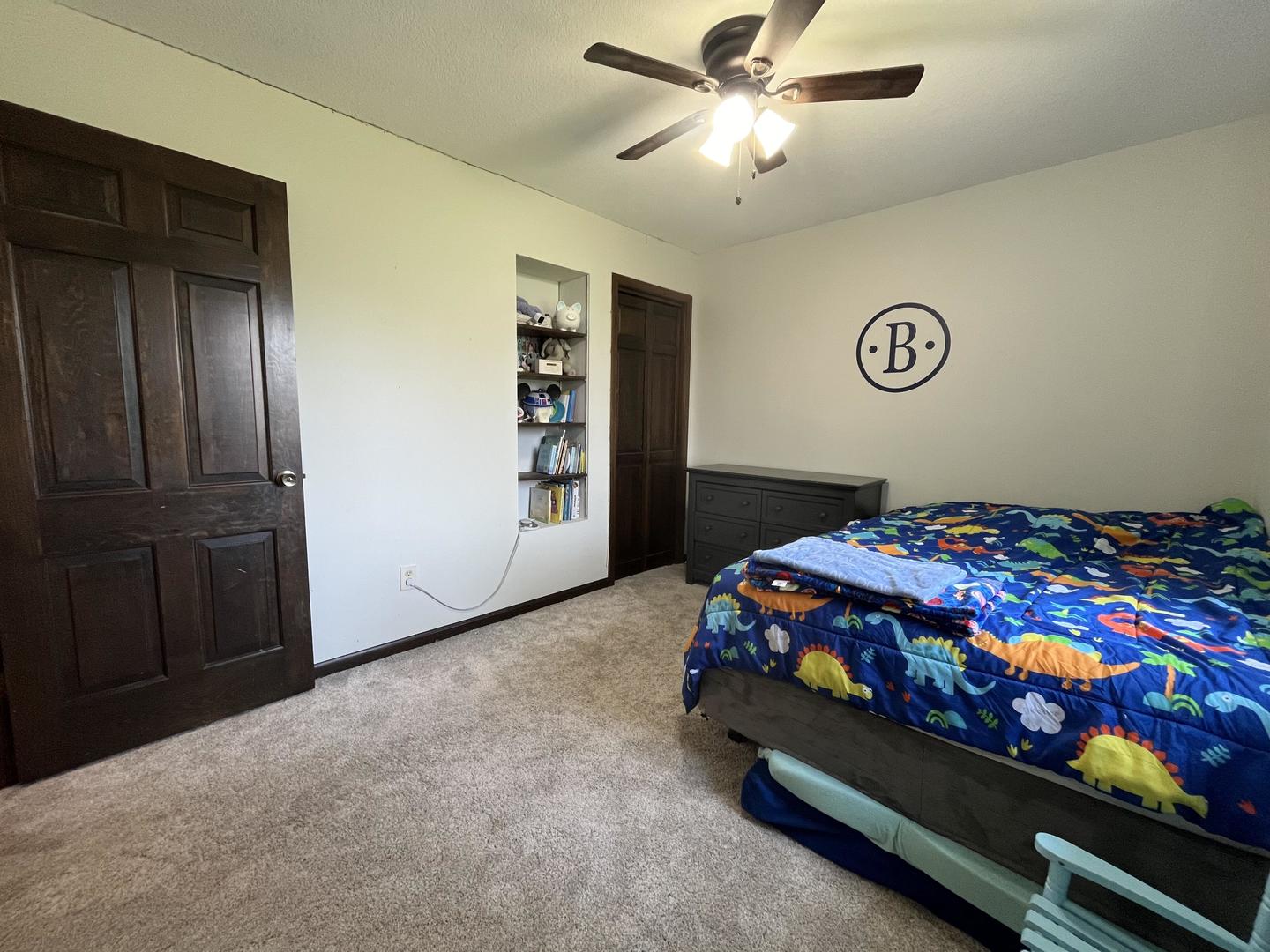 57 Jibby Estates Sullivan, IL 61951 - Photo 13 of 16 a bedroom with a bed and a chandelier